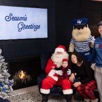 Crying baby on Santa's lap with mom and dad